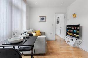 a living room with a table and a couch at Apartment in Hertfordshire in Hemel Hempstead