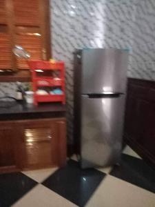 a stainless steel refrigerator sitting in a kitchen at Leng Seng Na Hotel in Battambang