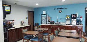 a restaurant with tables and chairs and a bar at Days Inn by Wyndham Willmar in Willmar