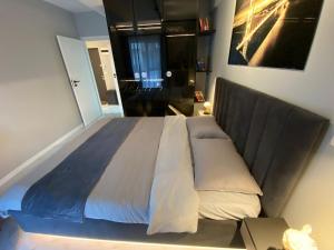 a large bed in a bedroom with a large bed frame at AIR Studio & Garden in Otopeni
