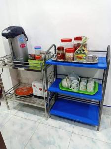 a blue shelf in a kitchen with food at Greenhouse homestay betong in Betong