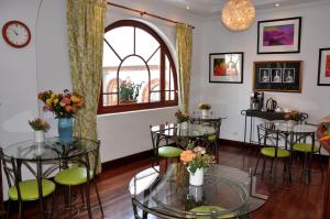 a room with tables and chairs and a window at Boutique Hotel Casa Foch in Quito