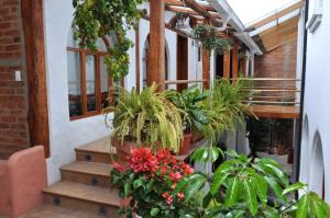 a porch with potted plants on the stairs at Boutique Hotel Casa Foch in Quito