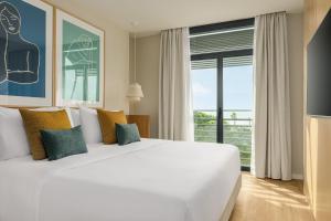 A bed or beds in a room at AC Hotel Gava Mar