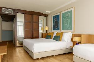 A bed or beds in a room at AC Hotel Gava Mar