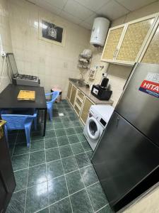 een keuken met een koelkast en een wasmachine bij العين الهيلي مصباح ب 5 in Al Ain