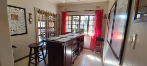 a kitchen with a counter and red curtains in a room at Montreux in Richards Bay