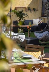 a patio with a table and chairs and a couch at La Casa del Gelsomino Palace in Acireale