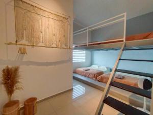 a bedroom with two bunk beds and a staircase at Evening/Night de Ville-50pax Private Pool BBQ in Ipoh