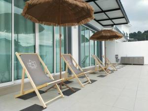 a row of chairs and umbrellas on a building at Evening/Night de Ville-50pax Private Pool BBQ in Ipoh +22 photos