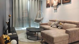 a living room with a couch and a table at De Luma-Metropol 3Bedrooms in Bukit Mertajam