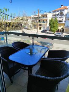 a blue table and chairs on a balcony at Δροσιά in Nafplio