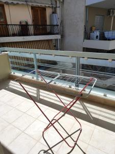 a metal bench sitting on top of a balcony at Δροσιά in Nafplio