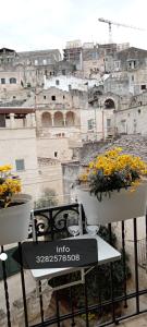 un tavolo con fiori in cima a un edificio di Radici - La finestra sui Sassi a Matera