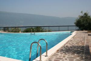 a swimming pool with a view of the water at La Limonaia - Theater Home in Gargnano