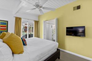 um quarto com uma cama e uma televisão na parede em R & R Rendezvous em Palm Springs