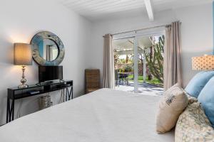 a bedroom with a bed and a sliding glass door at R & R Rendezvous in Palm Springs