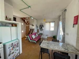 a kitchen and living room with a refrigerator and a table at Casita de renta frente la playa in San Juanico