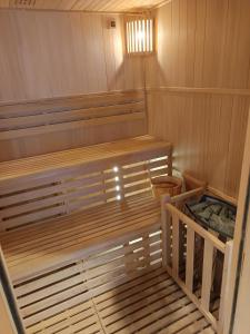 eine Sauna mit einer Holzbank in einem Zimmer in der Unterkunft jolie maison neuve - malisone - in Pont-Sainte-Maxence