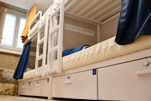 a bunk bed in a room with drawers at Albergue SP 55 by Bossh! Hotels in Santiago de Compostela