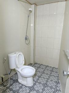 a bathroom with a toilet and a shower at Jogja Amor Hotel in Demangan