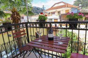 a bottle of wine sitting on a table on a balcony at Villa Palma Center in Berat
