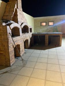 an outdoor kitchen with a brick oven in a house at شاليه للايجار اليومي بالريف الاوروبي in Qaryat ash Shamālī