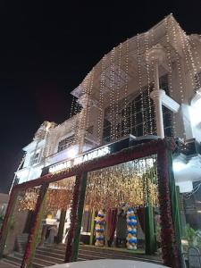 a building decorated with christmas lights in front of it at Hotel Samrat Heavens Meerut in Meerut