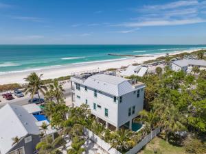 una vista aerea di un edificio bianco e della spiaggia di Villa Rayo Del Sol a Bradenton Beach