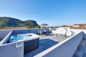 a hot tub on the roof of a house at Panoramic Apartment Rudi in Garda