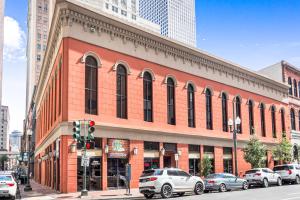 un edificio de ladrillo rojo con coches aparcados delante de él en Chuck's Place, en Nueva Orleans