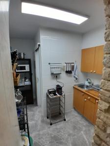 a kitchen with a sink and a counter top at Guesthouse Antonio in Alicante