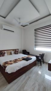 a bedroom with a large bed and a window at Hotel triple s in Karnal