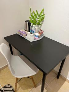 a black desk with a plant on top of it at Kicauan RoomStay #1 Kuala Berang-Free WiFi & Netflix for 2 Pax in Kuala Berang