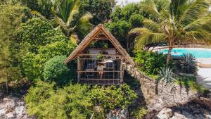 an aerial view of a house next to a pool at Marafiki Bungalows in Kiwengwa
