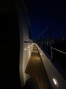 a boat with a wooden deck at night at ESESYATTURİZM in Istanbul