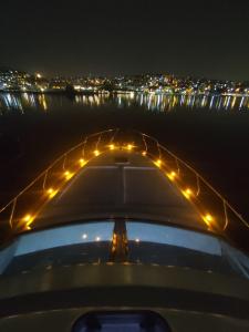 a view of a boat at night with lights at ESESYATTURİZM in Istanbul