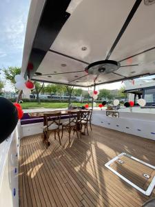 a wooden deck with tables and chairs on a boat at ESESYATTURİZM in Istanbul