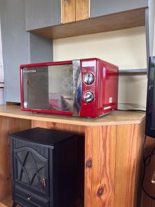 a red microwave sitting on top of a counter at Retro Mobile glamping - Near Dartmoor walks in Exeter