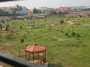 a view of a field with a playground at Hotel Park View Near Sea Beach in Puri