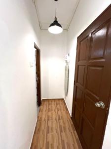 an empty hallway with a door and a light at Kicauan RoomStay #2 Kuala Berang-Free WiFi & Netflix for 2 Pax in Kuala Berang