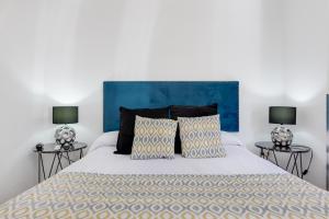 a bedroom with a large bed with two lamps at Hotel Madrid in Torrevieja