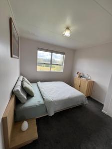 a bedroom with a bed and a window at Private Room in Kawakawa