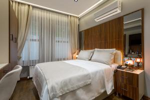 a bedroom with a large white bed and a window at Dream Park Hotel in Istanbul