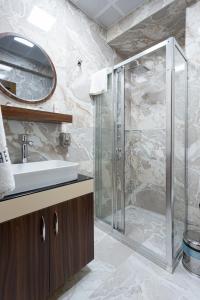 a bathroom with a glass shower and a sink at Dream Park Hotel in Istanbul