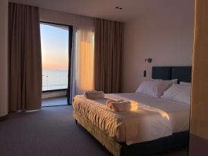 a hotel room with a bed with a view of the ocean at Manta Hotel in Ksamil