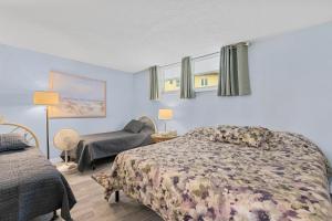 a bedroom with a bed and a chair and a couch at Coronado Towers 703 in New Smyrna Beach +56 photos