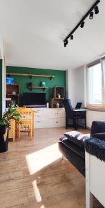 a living room with a couch and a tv at Ostoja Metro Bródno Warszawa in Warsaw