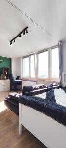 a bedroom with two beds and a room with windows at Ostoja Metro Bródno Warszawa in Warsaw