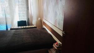 a small bedroom with a bed and a window at Marina free parking in Budapest